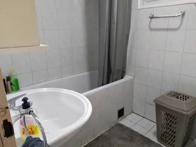 a bathroom with a white tub and a toilet at Sweet Dream Rooms in Podgorica