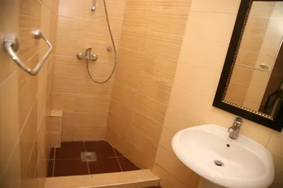 a bathroom with a sink and a shower with a mirror at Bugi in Kotor