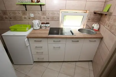 a small kitchen with a sink and a counter at Bugi in Kotor