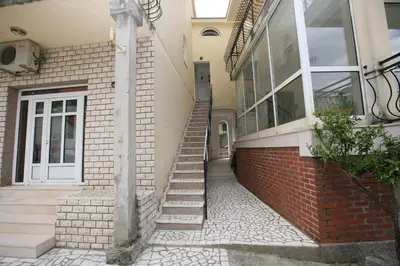 a house with a staircase leading to a door at Bugi in Kotor
