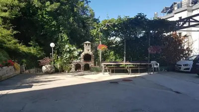 a parking lot with a picnic table and a building at Belveder Montenegro in Rafailovici