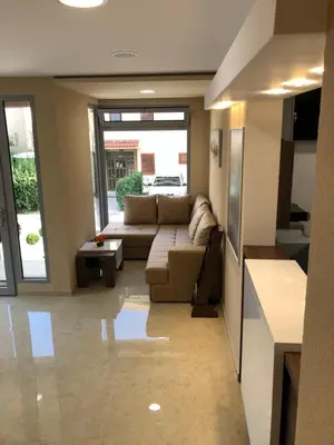 a living room with a couch and a table at Al Mare apartments Budva in Budva