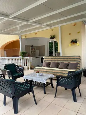 a patio with a couch and chairs and a table at Apartment Tanya in Petrovac na Moru