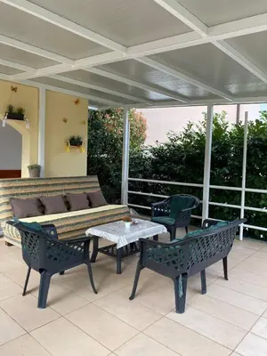 a patio with a couch and a table and chairs at Apartment Tanya in Petrovac na Moru