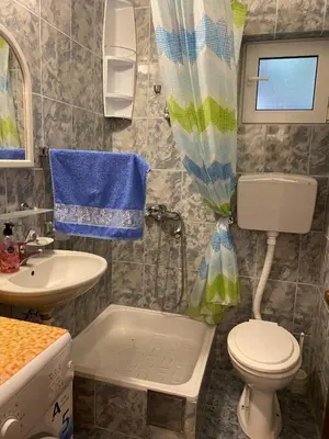 a small bathroom with a toilet and a sink at Apartment Tanya in Petrovac na Moru