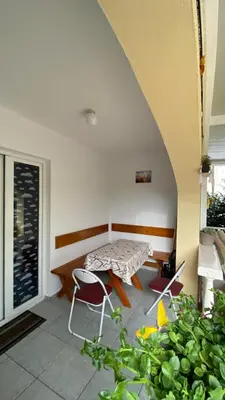 a patio with a table and chairs in a room at Apartment Tanya in Petrovac na Moru