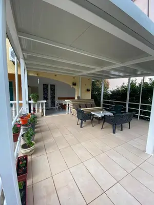 a patio with benches and a table and chairs at Apartment Tanya in Petrovac na Moru