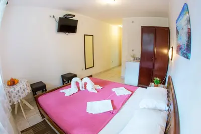 a bedroom with a bed with two towels on it at Guest House Mandarina in Budva