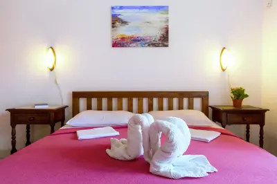 two towel animals are sitting on a bed at Guest House Mandarina in Budva