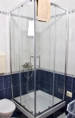a shower stall in a bathroom with a toilet at Guest House Mandarina in Budva