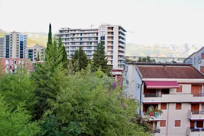 a group of buildings in a city with trees at Guest House Mandarina in Budva