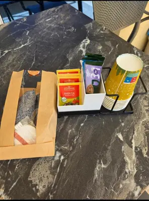 a table with a box of food on a table at Anja & Ogo apartments with Pool 2 in Petrovac na Moru