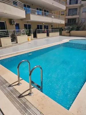 a swimming pool with blue water in a building at Anja & Ogo apartments with Pool 2 in Petrovac na Moru