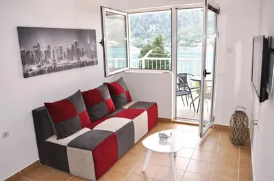 a living room with a couch and a table at Dream Bay View Loki in Kotor