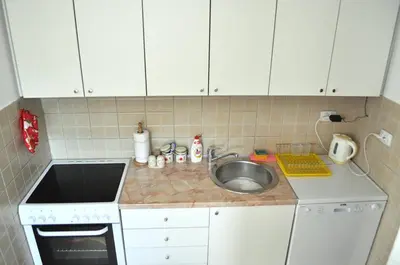 a small kitchen with a sink and a stove at Dream Bay View Loki in Kotor