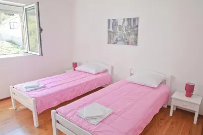 two beds in a room with pink sheets at Dream Bay View Loki in Kotor