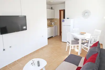 a living room with a couch and a table at Dream Bay View Loki in Kotor