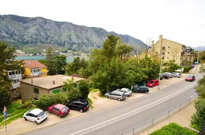 a street with cars parked on the side of a road at Central Apartment in Kotor