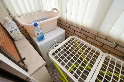 a washing machine with a basket next to a washer at Central Apartment in Kotor