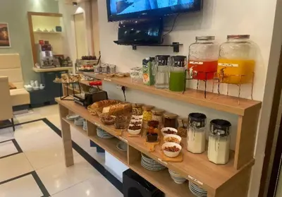 a shelf filled with different types of drinks and pastries at Meridian Hotel in Budva
