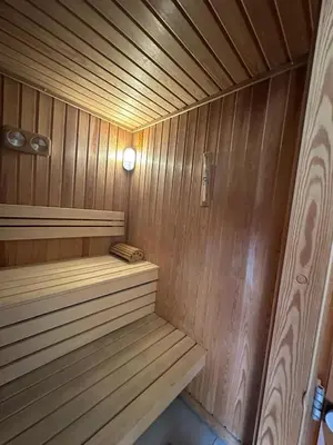 a wooden sauna with a bench in a room at Meridian Hotel in Budva