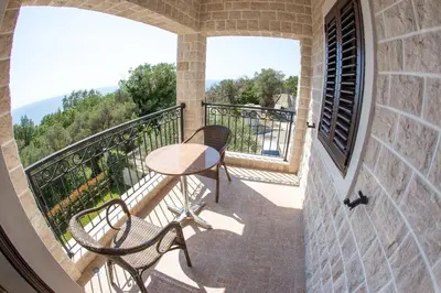 a patio with a table and chairs on a balcony at Townhouse Virginia in Petrovac na Moru