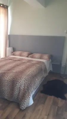a bed in a bedroom with a wooden floor at Апартаменты Ирина М in Bar