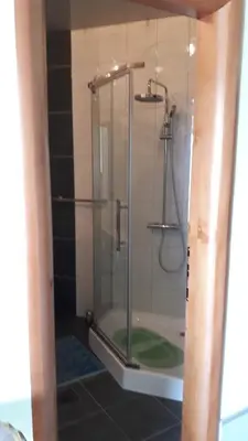 a shower with a glass door in a bathroom at Апартаменты Ирина М in Bar