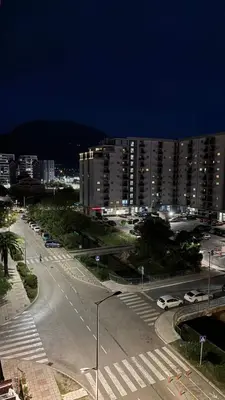 a city street with cars parked in front of a building at Апартаменты Ирина М in Bar