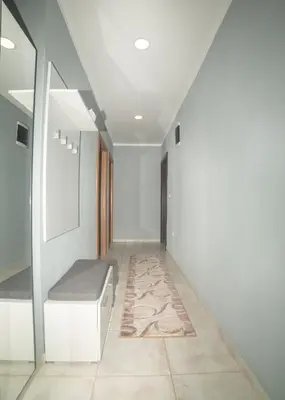 a hallway with a bench and a rug at Apartment Milena in Virpazar