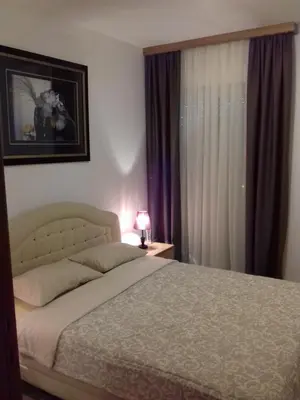a bedroom with a bed and a window at Aleksandra in Becici