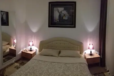 a bedroom with a bed and two lamps on tables at Aleksandra in Becici