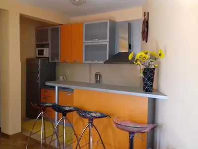 a kitchen with two bar stools and a counter top at Aleksandra in Becici
