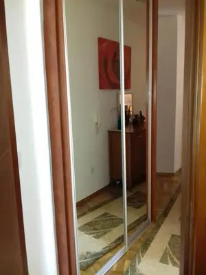a mirror in a hallway with a room at Aleksandra in Becici