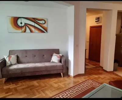 a living room with a couch and a painting on the wall at Aleksandra in Becici
