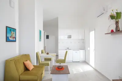 a living room with a couch and a table at Sunset Apartments in Ulcinj