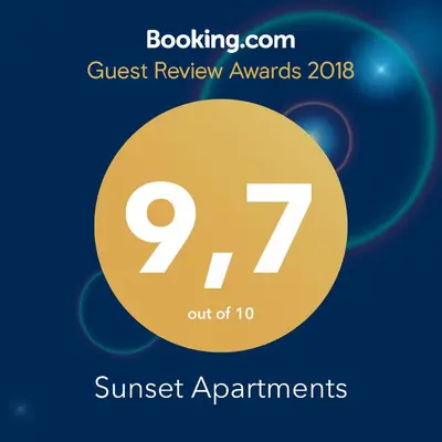 a sign that reads guest review awards with a yellow circle at Sunset Apartments in Ulcinj