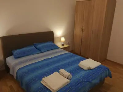 a bedroom with a bed with two towels on it at Apartment Misulino in Kotor