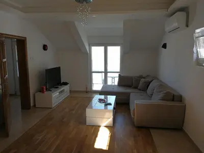 a living room with a couch and a tv at Apartment Misulino in Kotor