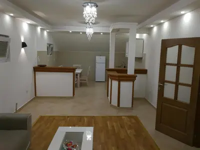 a living room and kitchen with a couch and a table at Apartment Misulino in Kotor