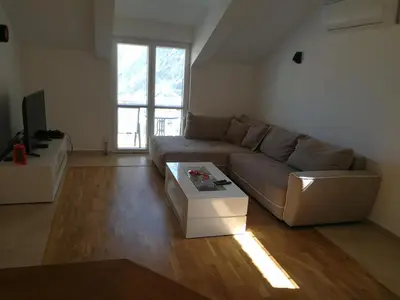 a living room with a couch and a coffee table at Apartment Misulino in Kotor