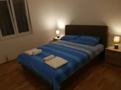 a bedroom with a bed with two towels on it at Apartment Misulino in Kotor