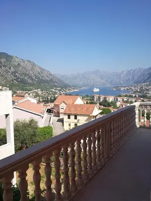a balcony with a view of a city and water at Apartment Misulino in Kotor