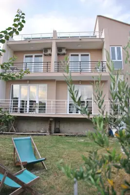 a large house with a balcony and a yard at Haamel Apartment in Ulcinj