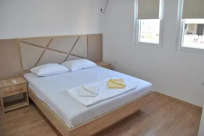 a bedroom with a bed with two towels on it at Haamel Apartment in Ulcinj