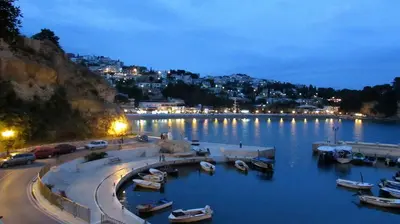 a harbor with boats in the water at night at Haamel Apartment in Ulcinj