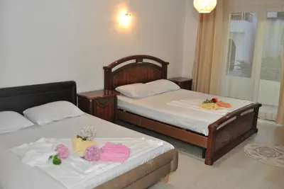 two beds in a hotel room with flowers on them at Haamel Apartment in Ulcinj