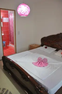 a bedroom with a bed with a pink bow on it at Haamel Apartment in Ulcinj