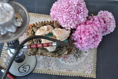 a basket of flowers on a table with a hair dryer at Haamel Apartment in Ulcinj