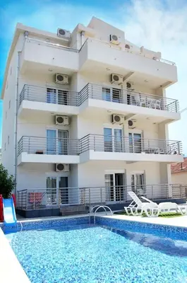 a building with a swimming pool in front of a building at Villa Swan in Bar